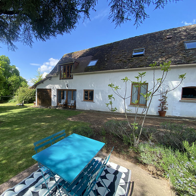 Welcome area with chairs, log burner & television